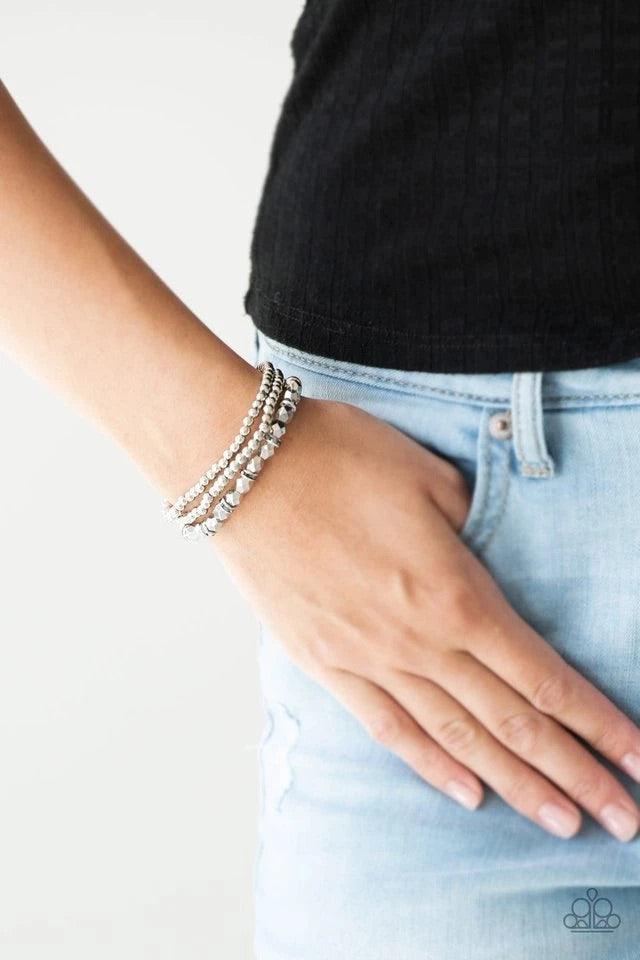 Paparazzi Accessories Let There BEAM Light - Silver Infused with hematite rhinestone encrusted rings, mismatched dainty silver and faceted silver beads are threaded along stretchy bands for a refined look. Sold as one set of three bracelets. Jewelry