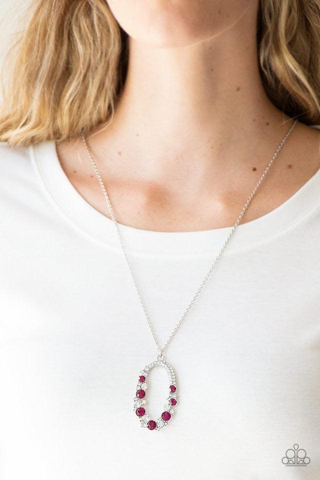 Paparazzi Accessories Spotlight Social - Pink Varying in size, an array of glittery white and pink rhinestones are encrusted along a shimmery silver hoop. The sparkling pendant swings from the bottom of an elongated silver chain for a glamorous finish. Fe
