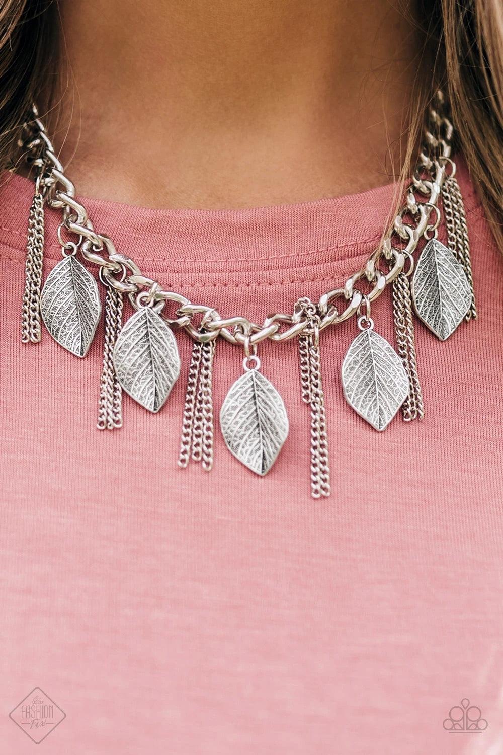 Paparazzi Accessories Serenely Sequoia - Silver Decorated in lifelike textures, glistening silver leaves swing from the bottom of a bold silver chain. Infused with sections of silver chain tassels, the leafy fringe drapes below the collar for a seasonal l