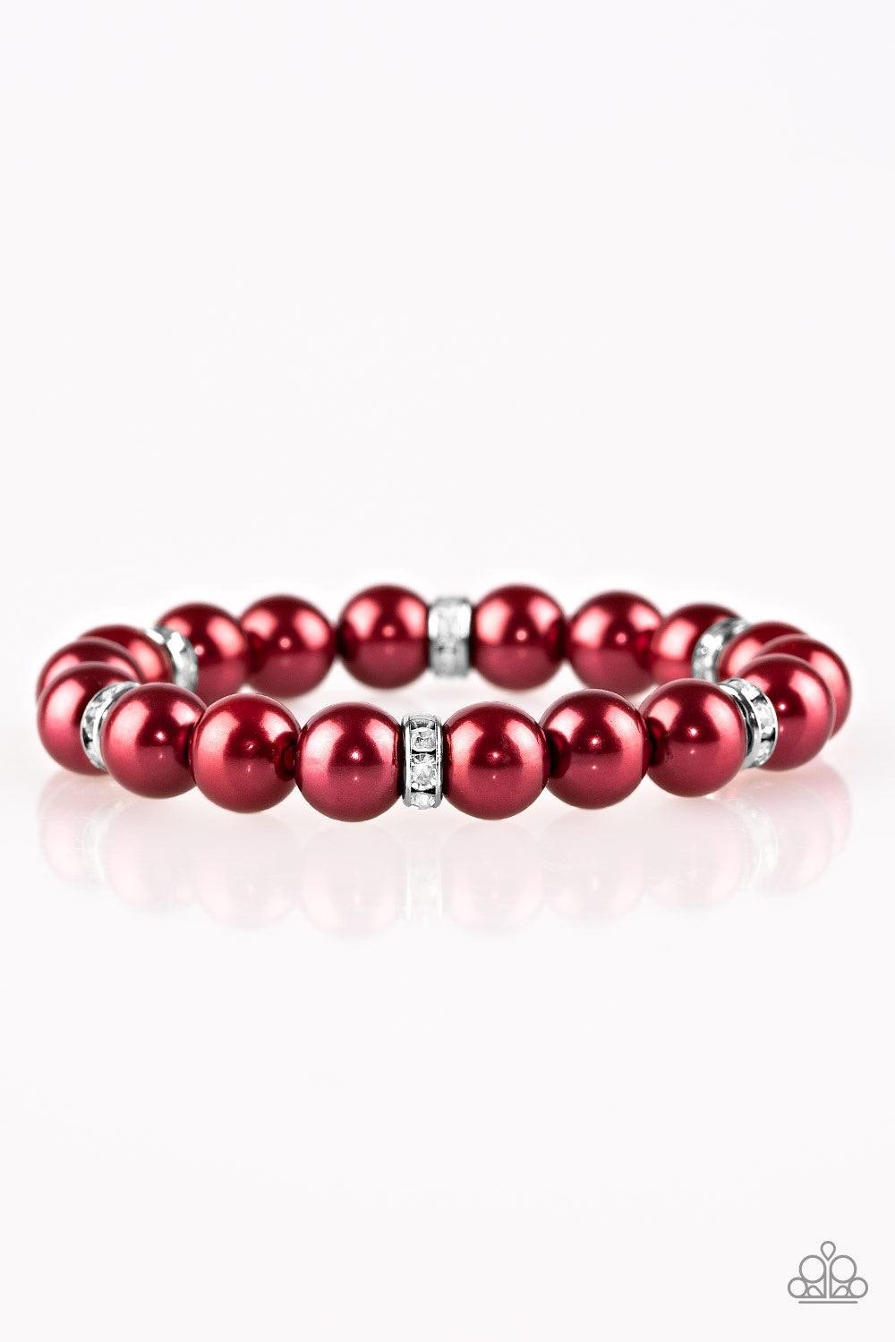 Paparazzi Accessories Exquisitely Elite - Red Classic red pearls and glittery white rhinestone encrusted rings are threaded along a stretchy band, creating a timeless centerpiece around the wrist. Jewelry