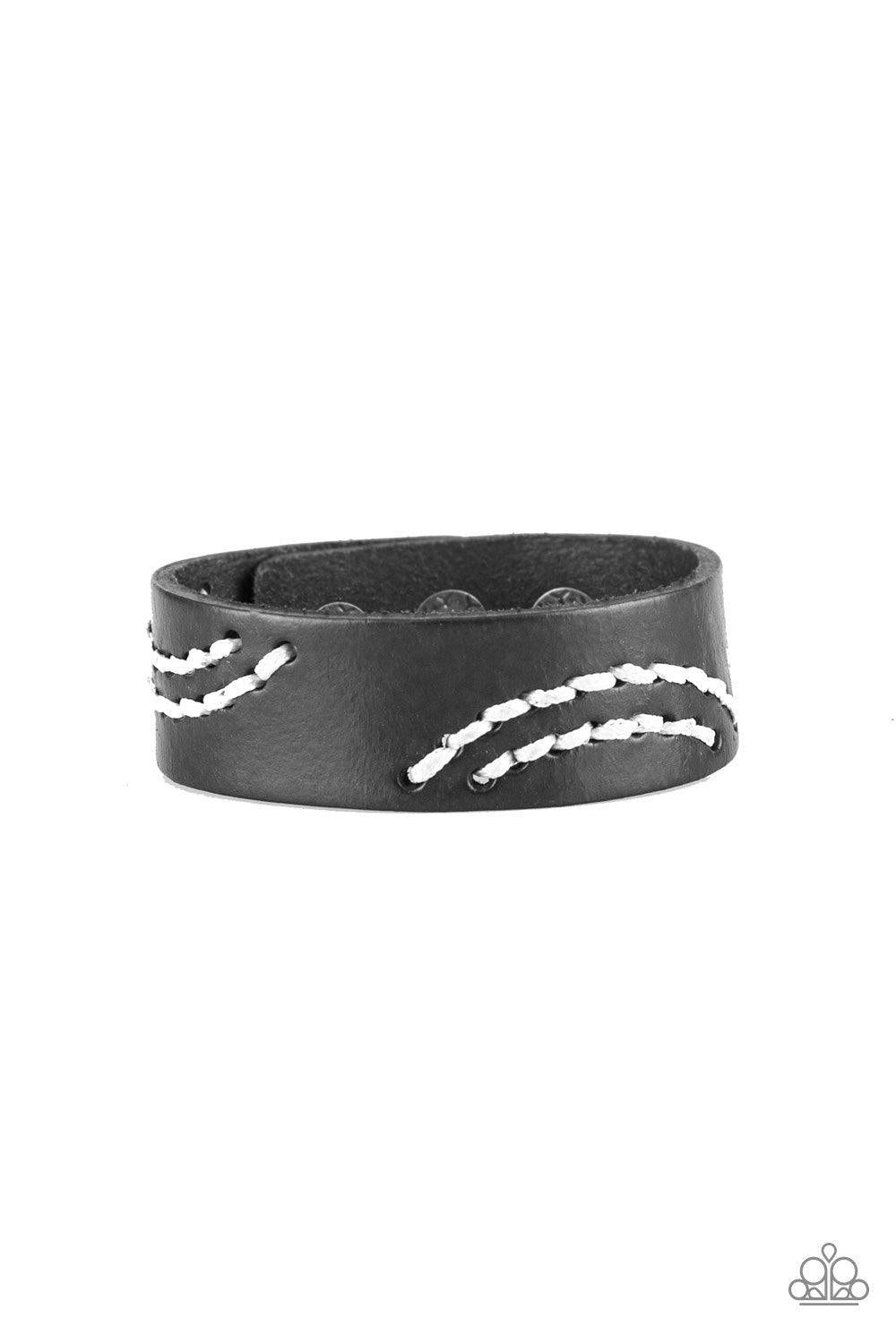 Paparazzi Accessories Rural Roamer - Black Sections of white cording is stitched across the front of a black leather band for a whimsical look. Features an adjustable snap closure. Jewelry