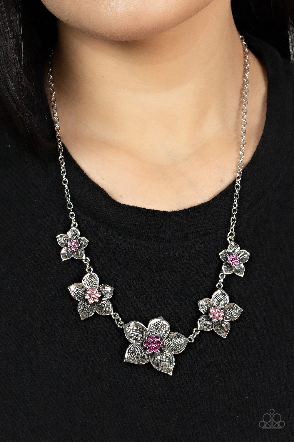 Paparazzi Accessories Wallflower Wonderland - Pink A charming collection of antiqued silver flowers in diminishing sizes delicately link across the collar. The detailed petals are etched in antiqued silver and fan out from lovely pink rhinestone centers r