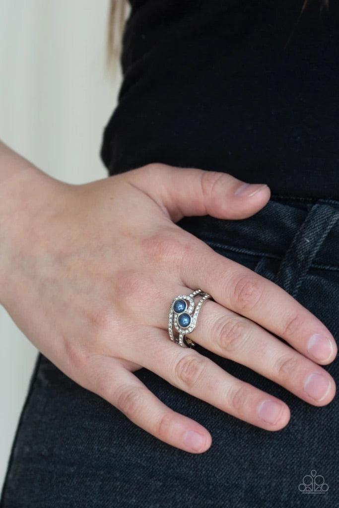 Paparazzi Accessories Collect Up Front - Blue Glittery white rhinestone encrusted bands swirl around a pair of dainty blue pearls for a refined look. Features a dainty stretchy band for a flexible fit. Sold as one individual ring. Jewelry