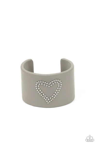 Paparazzi Accessories Rodeo Romance - Silver The center of an Ultimate Gray leather cuff is studded in a charming heart pattern, creating a rustically romantic look around the wrist. Sold as one individual bracelet. Jewelry
