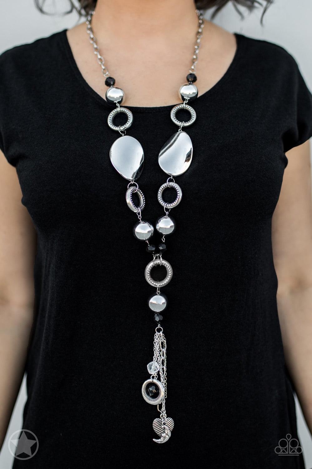 Paparazzi Accessories Total Eclipse Of The Heart - Silver Long chain of black crystalized beads, curved plates of silver with a pearly finish, and chunky silver rings lead down to a tassel of chains and charms, including a crescent moon and a heart. Jewel