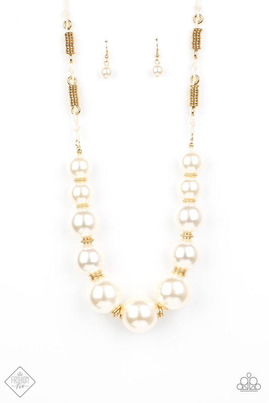 Paparazzi Accessories Pearly Prosperity - Gold Separated by stacks of smooth and decorative gold rings, a collection of dramatically oversized white pearls are delicately hand-strung along an invisible wire that attaches to knotted strands of white cordin