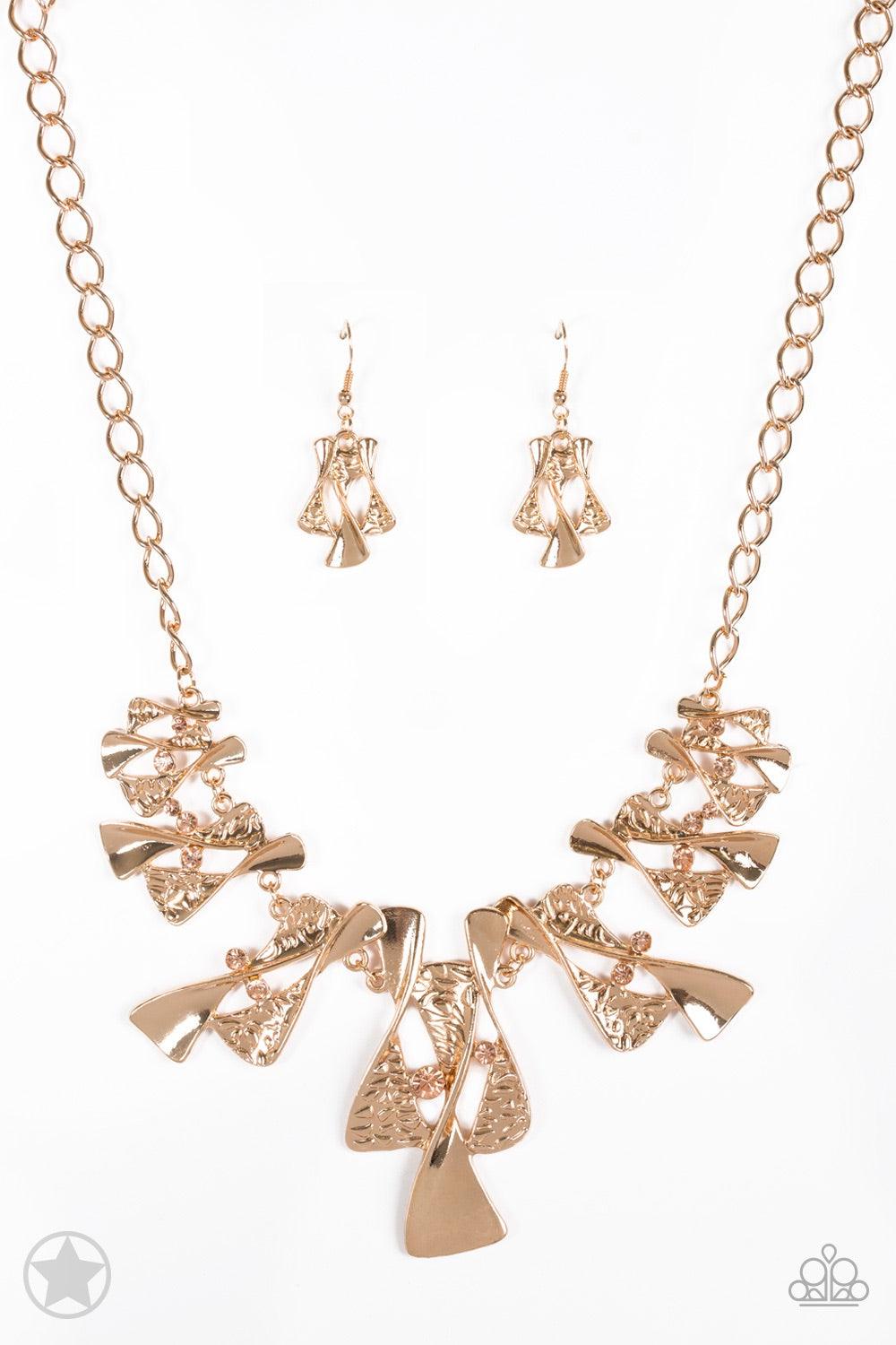 Paparazzi Accessories The Sands Of Time - Gold Twisted gold hourglasses dance along a chunky gold chain with tiny peach rhinestones adding sparkling, elegant accents. Beautiful textured pieces add depth to the design. Features an adjustable clasp closure.