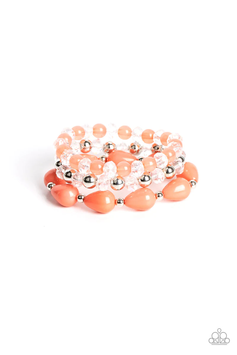 Paparazzi Accessories Beachside Brunch - Orange A whimsical assortment of crystal-like beads, silver beads, opaque coral beads, and coral teardrop beads are threaded along stretchy bands around the wrist, resulting in colorful layers. Sold as one set of t