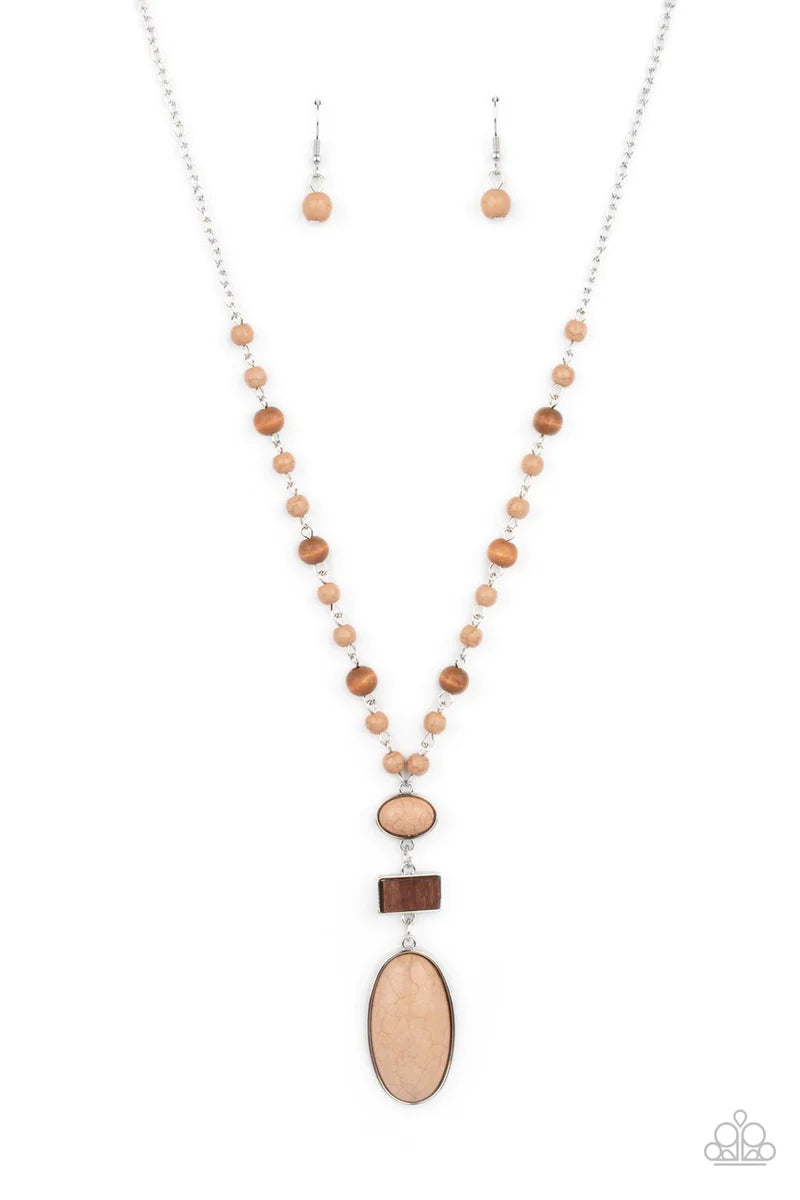 Paparazzi Accessories Naturally Essential - Brown A dainty collection of Desert Mist stones and rustic wooden beads connect into an earthy chain across the chest. Featuring sleek silver frames, oval Desert Mist stones and a rectangular wooden frame connec