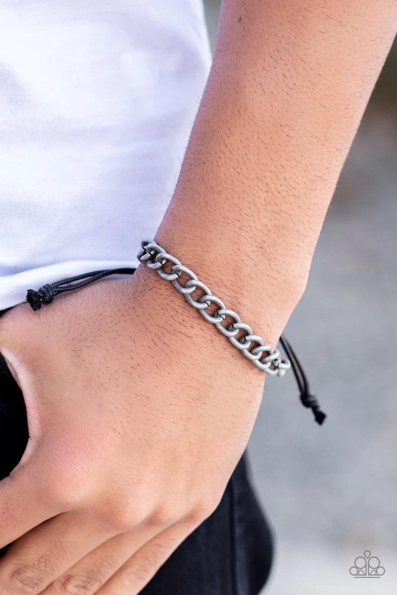 Paparazzi Accessories Sideline - Silver Shiny black cording knots around the ends of a tin-finished silver cable chain that is wrapped across the top of the wrist for a versatile look. Features an adjustable sliding knot closure. Sold as one individual br