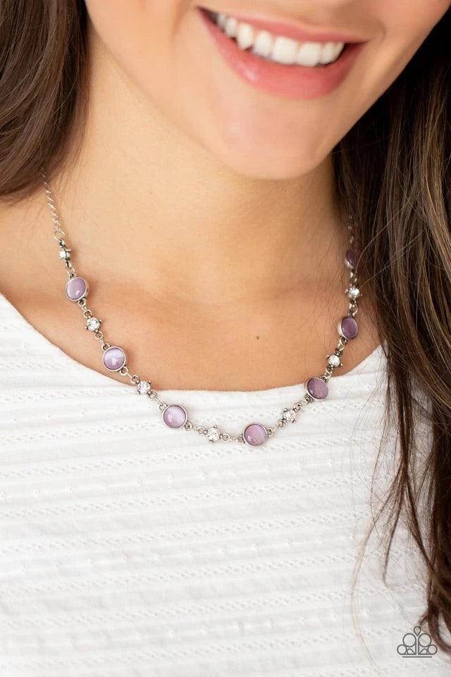 Paparazzi Accessories Inner Illumination - Purple Encased in antiqued silver fittings, dainty white rhinestones and glowing Amethyst Orchid cat's eye stones delicately link below the collar for a timeless finish. Features an adjustable clasp closure. Sold