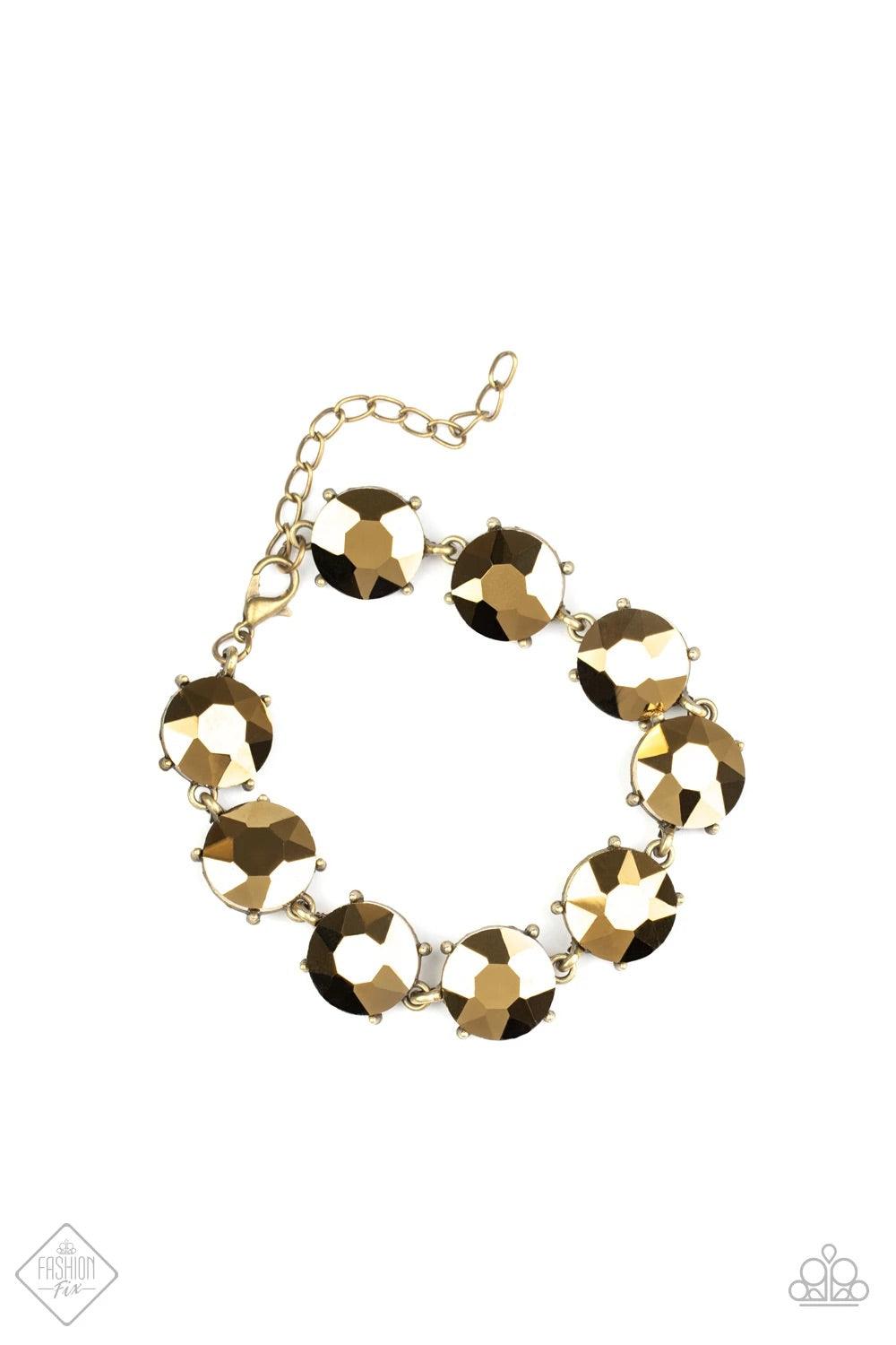 Paparazzi Accessories Fabulously Flashy ~Brass Nestled inside classic brass fittings, a collection of oversized aurum rhinestones delicately links around the wrist for a flashy finish. Features an adjustable clasp closure. Sold as one individual. Jewelry