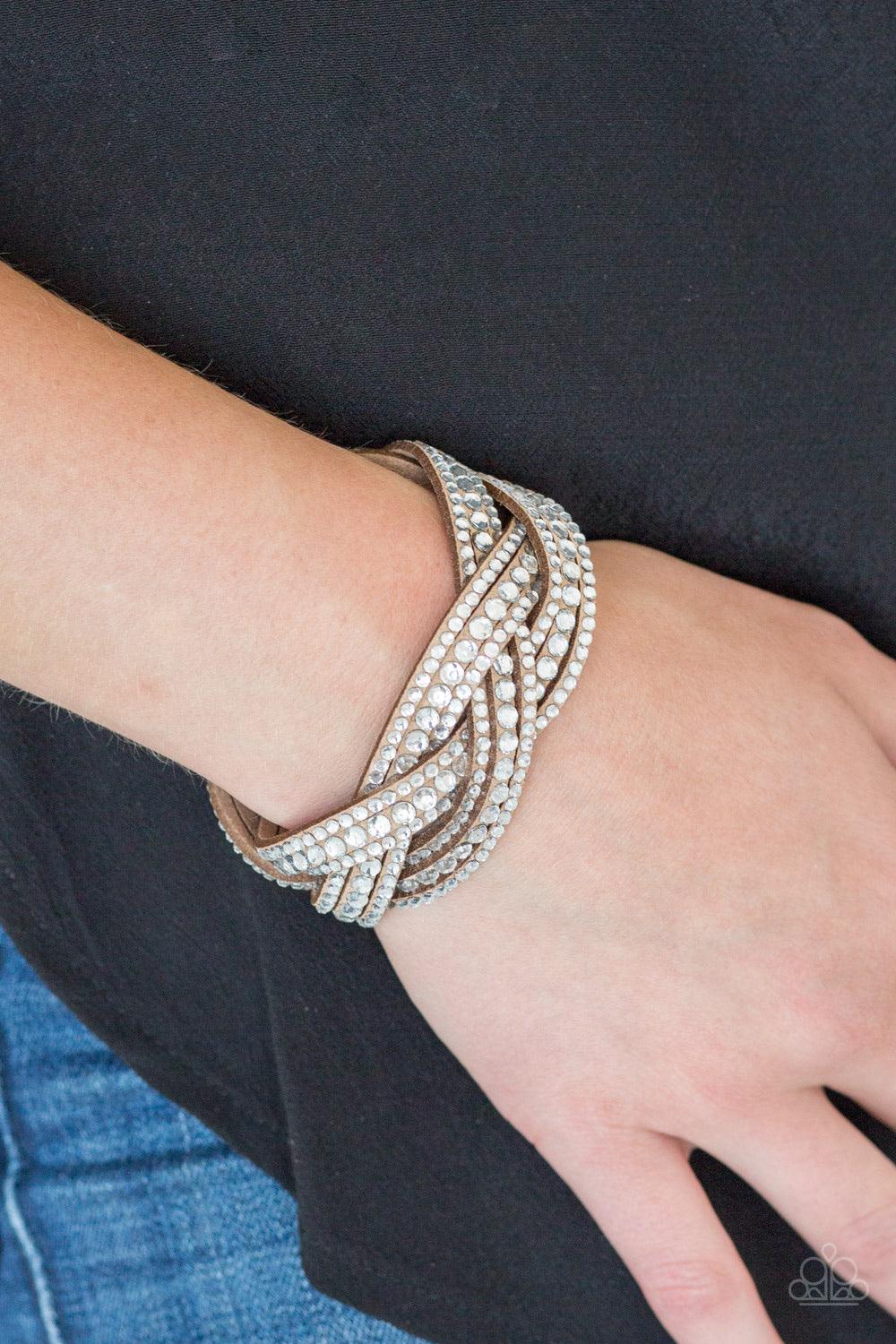 Paparazzi Accessories Bring On The Bling - Brown Varying in size, glassy white rhinestones are encrusted along interwoven brown suede bands, creating blinding shimmer across the wrist. Features an adjustable snap closure. Sold as one individual bracelet.