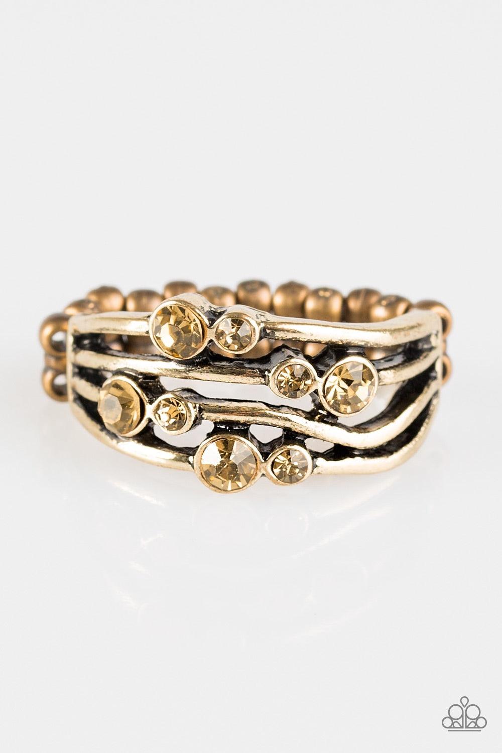 Paparazzi Accessories Welcome to GLEAMland - Brass Glittery topaz rhinestones are sprinkled across wavy brass bars, creating a refined band. Features a dainty stretchy band for a flexible fit. Jewelry