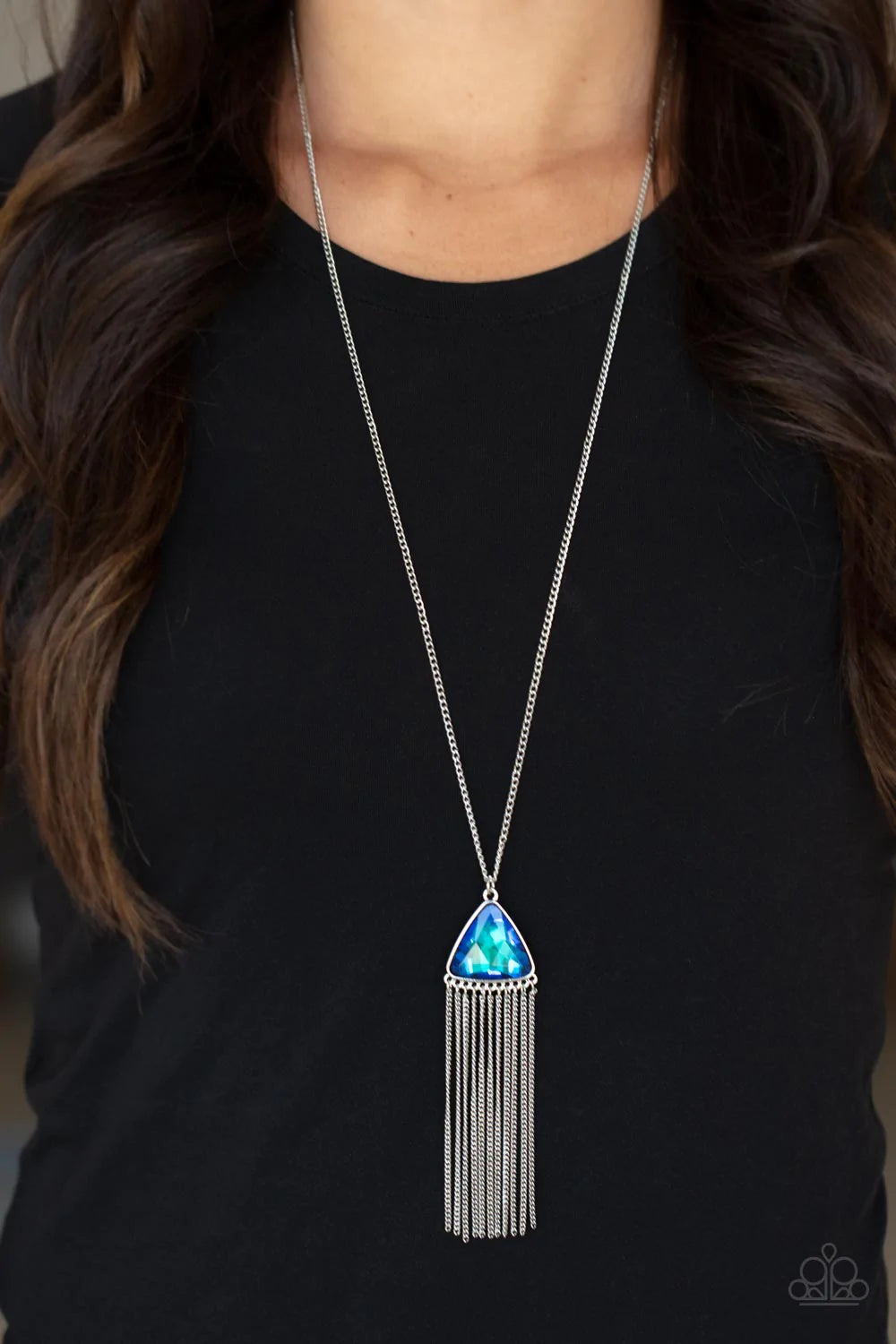 Paparazzi Accessories Proudly Prismatic - Blue Featuring an iridescent UV shimmer, an oversized blue triangular gem swings from the bottom of a lengthened silver chain. A curtain of silver chains streams out from the bottom of the sparkly pendant, adding