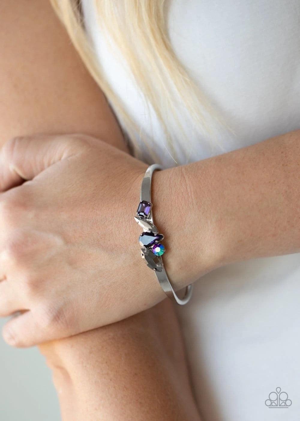 Paparazzi Accessories Gemstone Grotto - Purple Varying in size and cut, an array of purple, hematite, and iridescent gems are encrusted along the top of a dainty silver cuff, creating a sparkling centerpiece. Sold as one individual bracelet. Jewelry