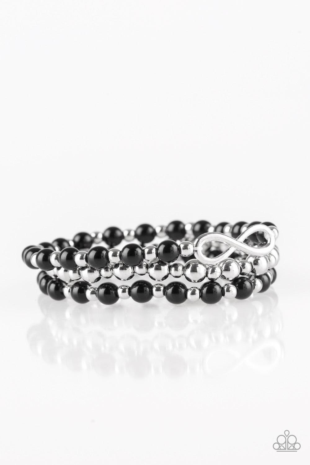 Paparazzi Accessories Immeasurable Infinite - Black Polished black and shiny silver beads are threaded along stretchy bands, creating colorful layers around the wrist. A dainty silver infinity charm adorns one strand for a whimsical finish. Sold as one se