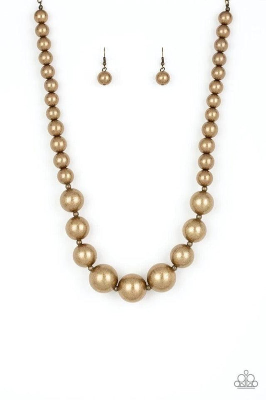 Paparazzi Accessories Living Up To Reputation - Brass A collection of bold brass beads are threaded along an invisible wire below the collar. The antiqued beads dramatically increase in size as they reach the center for an undeniable statement-making fini