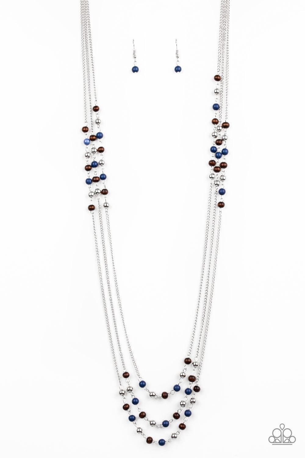Paparazzi Accessories Seasonal Sensation - Blue Dainty silver, blue, and wooden beads trickle along three shimmery silver chains, creating colorful layers across the chest. Features an adjustable clasp closure. Sold as one individual necklace. Includes on