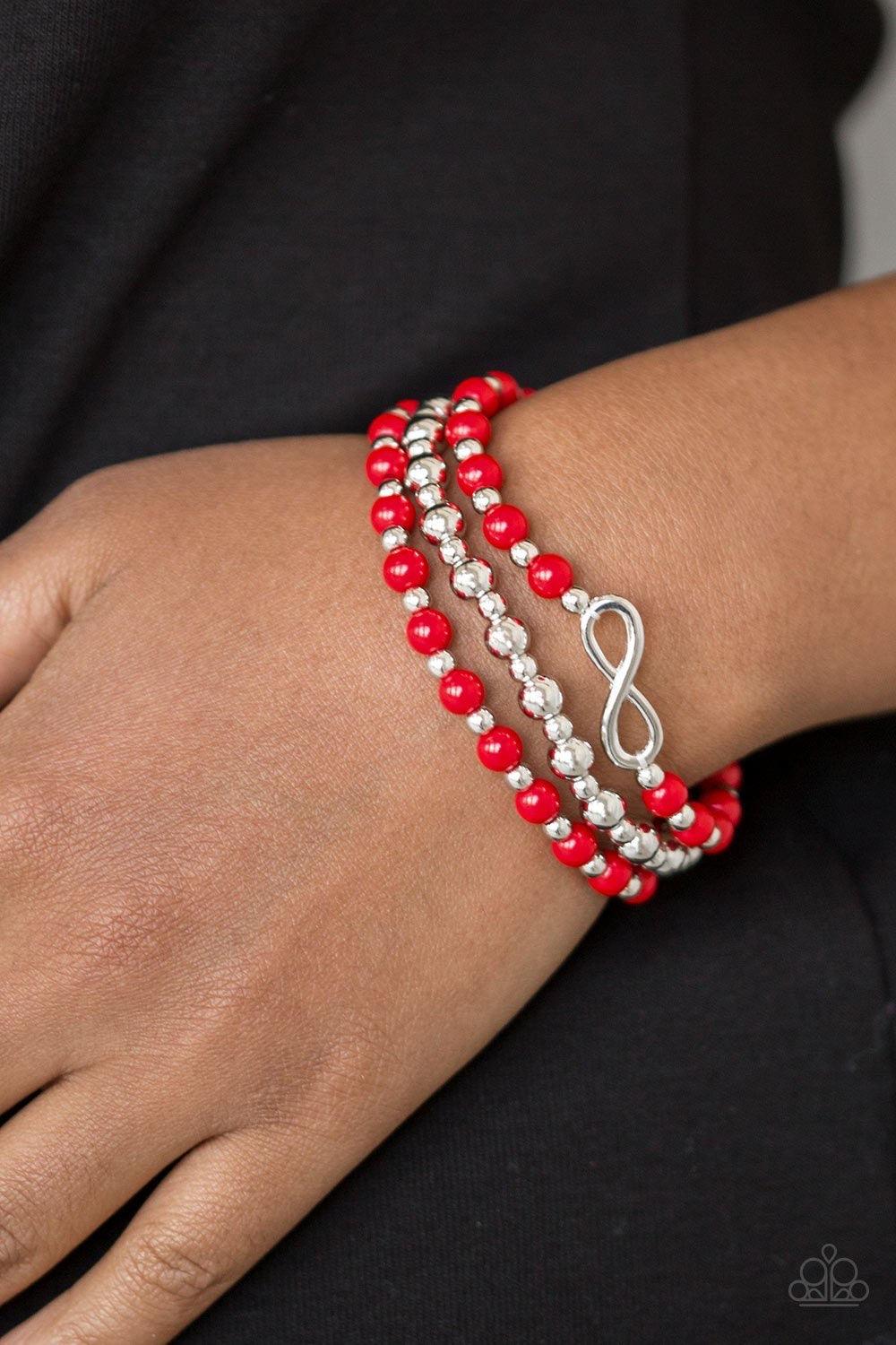 Paparazzi Accessories Immeasurably Infinite - Red Fiery red and shiny silver beads are threaded along stretchy bands, creating colorful layers around the wrist. A dainty silver infinity charm adorns one strand for a whimsical finish. Sold as one set of th