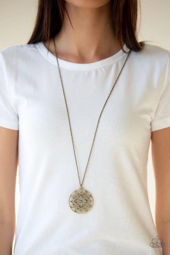 Paparazzi Accessories Mandala Melody - Brass Featuring a whimsical mandala pattern, a glistening brass pendant swings from the bottom of a lengthened brass chain for a seasonal look. Features an adjustable clasp closure. Sold as one individual necklace. I