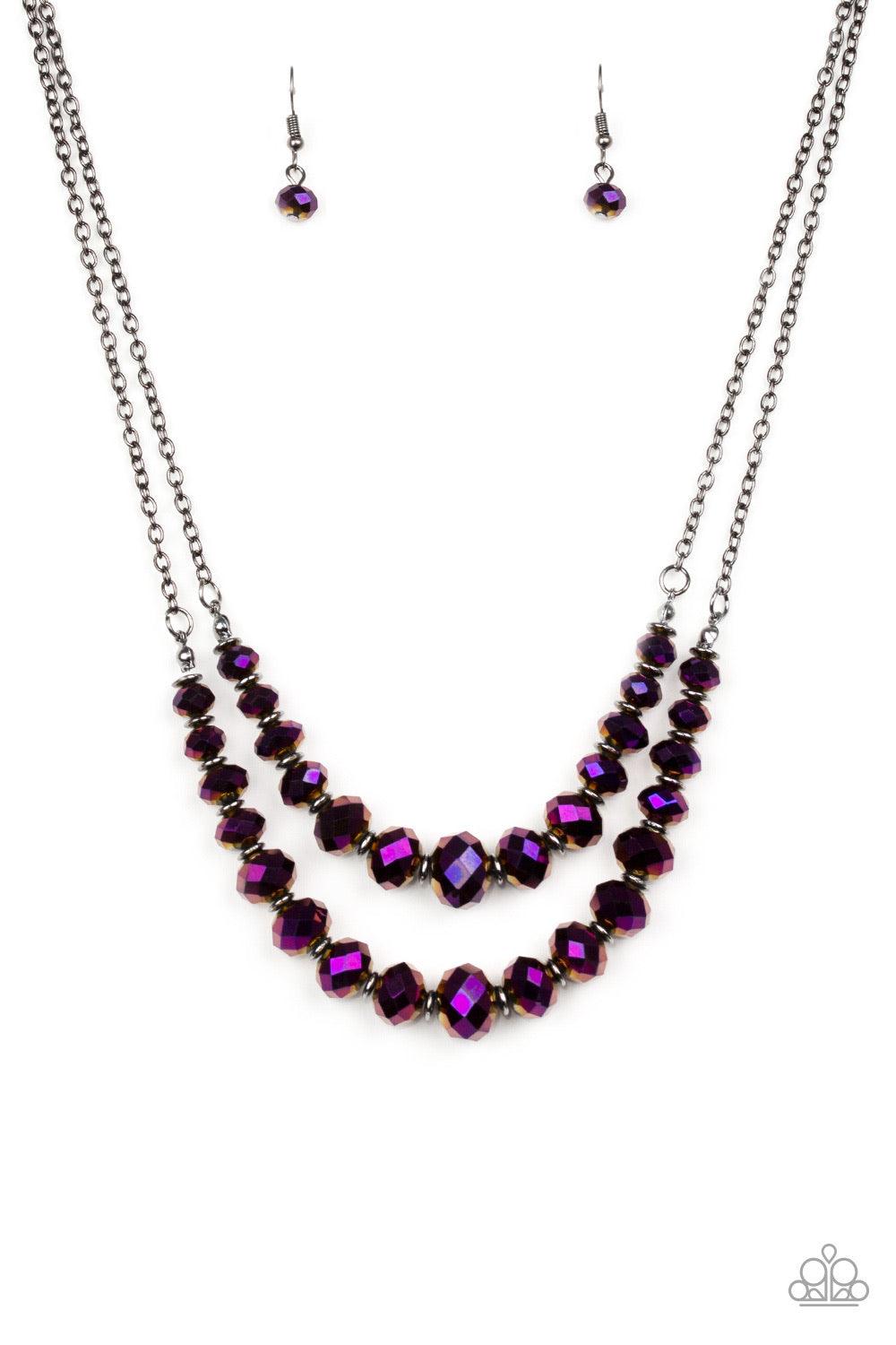 Paparazzi Accessories Strikingly Spellbinding - Purple Brushed in an iridescent shimmer, metallic purple gems are threaded along invisible wires, creating gorgeous layers beneath the collar. The glittery gems gradually increase in size near the center for