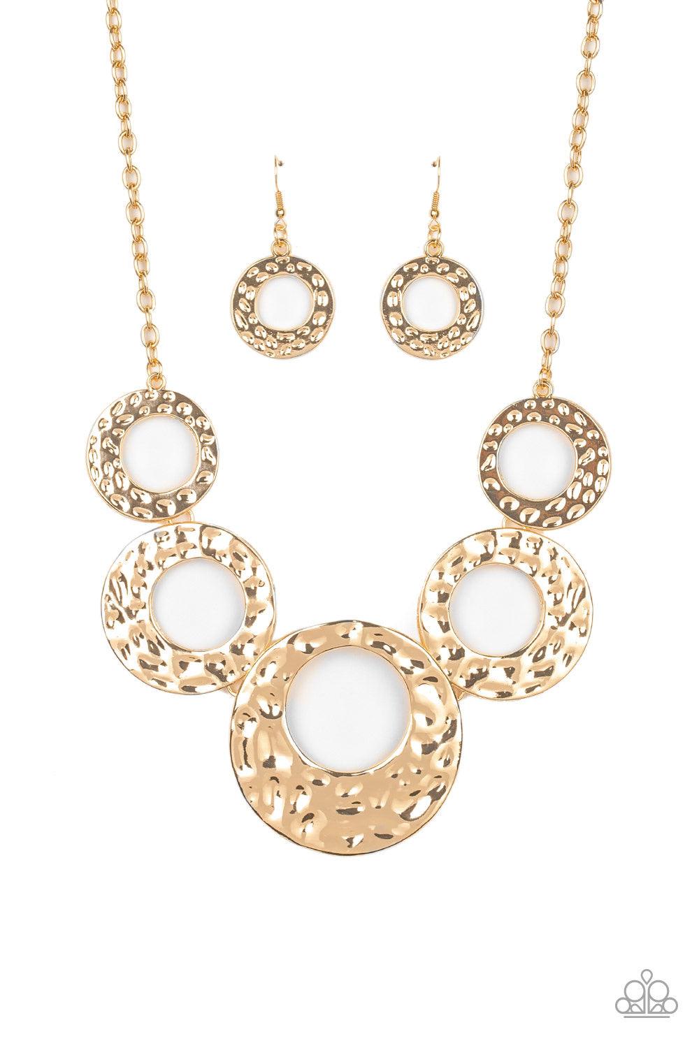 Paparazzi Accessories Mildly Metro - Gold Gradually increasing in size, hammered gold circles link below the collar for a statement-making look. Features an adjustable clasp closure. Jewelry