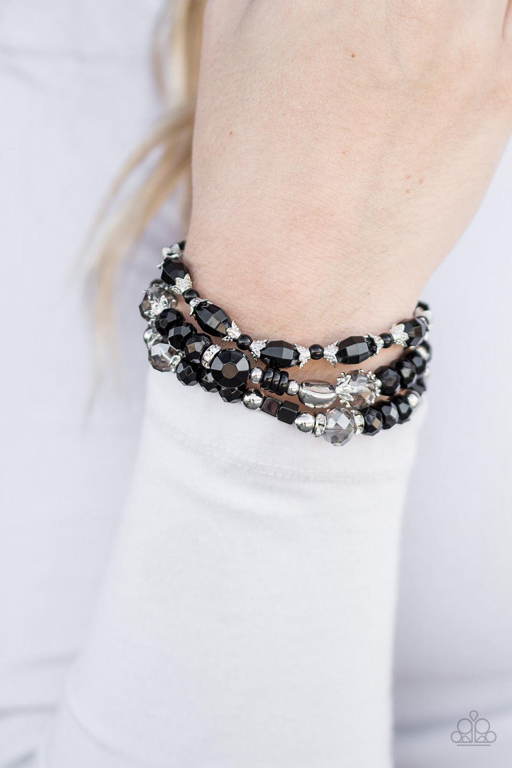 Paparazzi Accessories Girl Boss - Black Encrusted in glittery white rhinestones, shimmery silver rings, classic silver beads, and neutral black beads are threaded along three stretchy elastic bands. Faceted crystal-like beads are sprinkled between the col