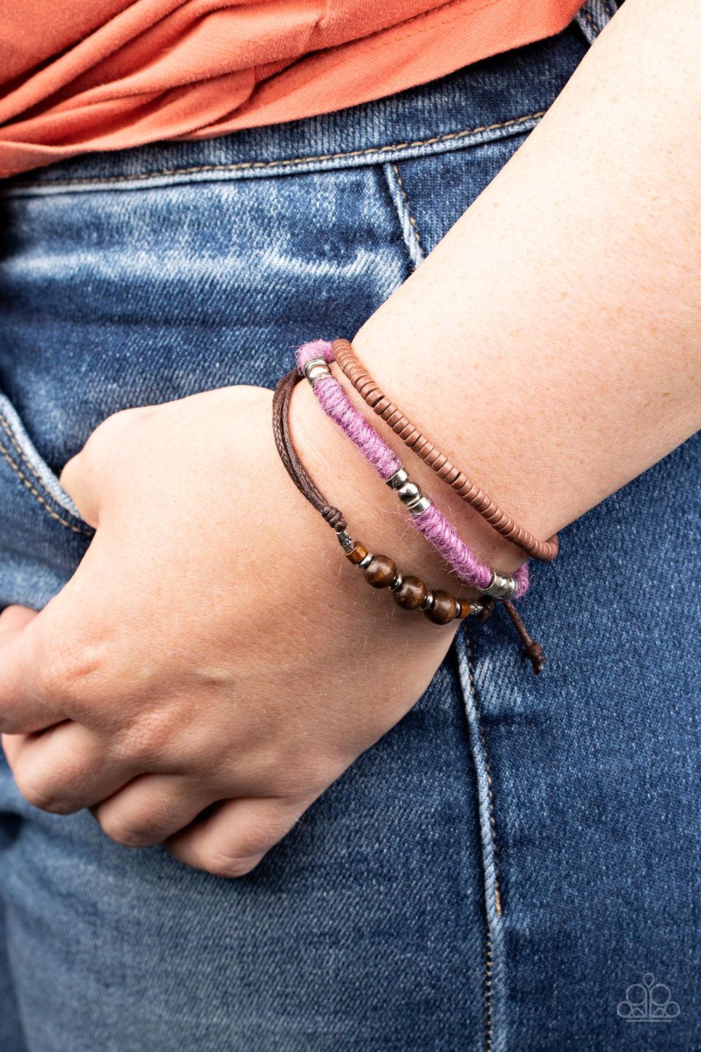 Paparazzi Accessories Totally Tiki - Purple Infused with wooden and silver accents, mismatched strands of purple twine and brown cording layer around the wrist for a colorfully seasonal look. Features an adjustable sliding knot closure. Sold as one indivi