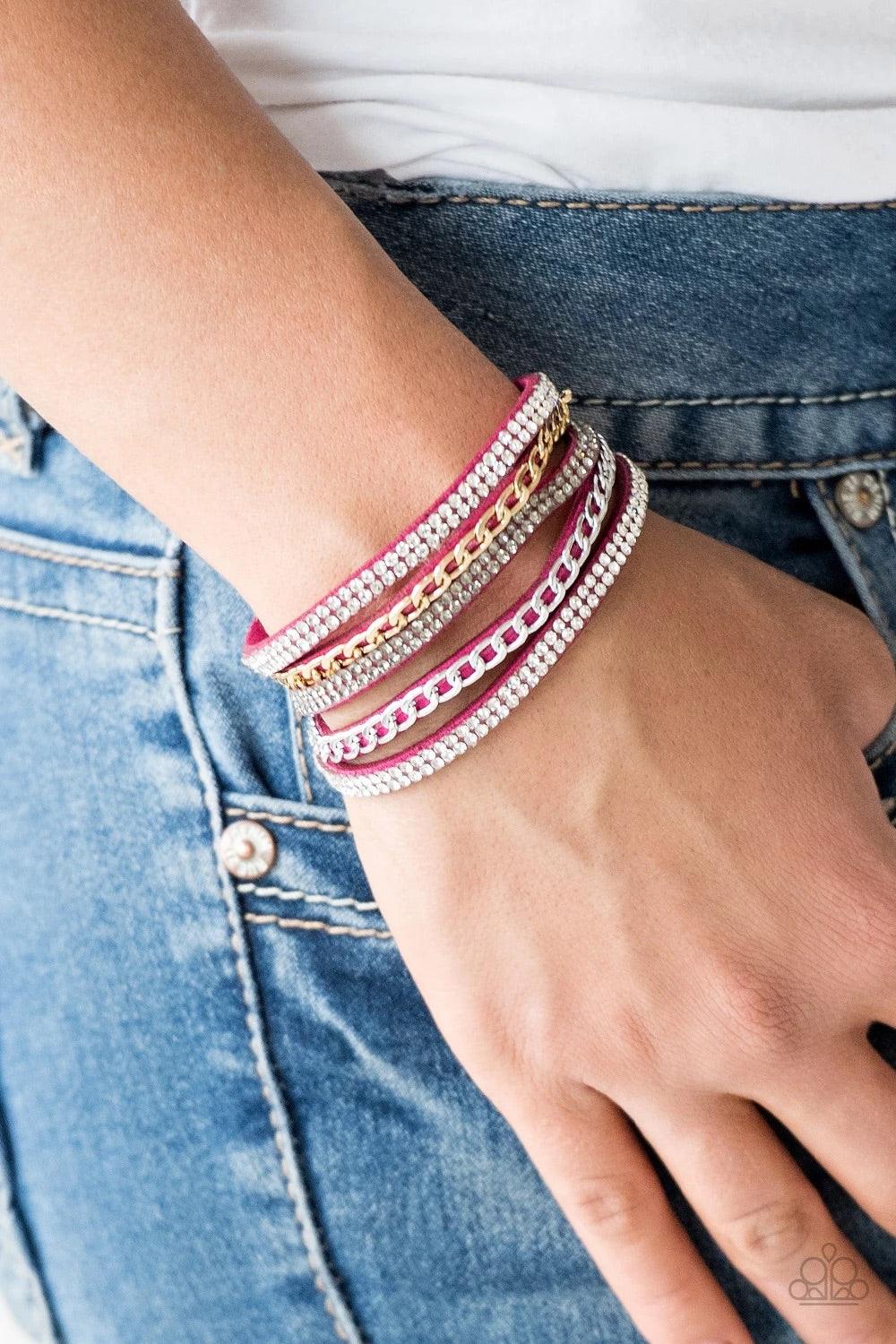 Paparazzi Accessories Fashion Fiend - Pink Glassy white and smoky rhinestones are encrusted along strands of pink suede. Glistening silver and gold chains are added to the bands, adding edgy industrial shimmer to the sassy palette. Features an adjustable