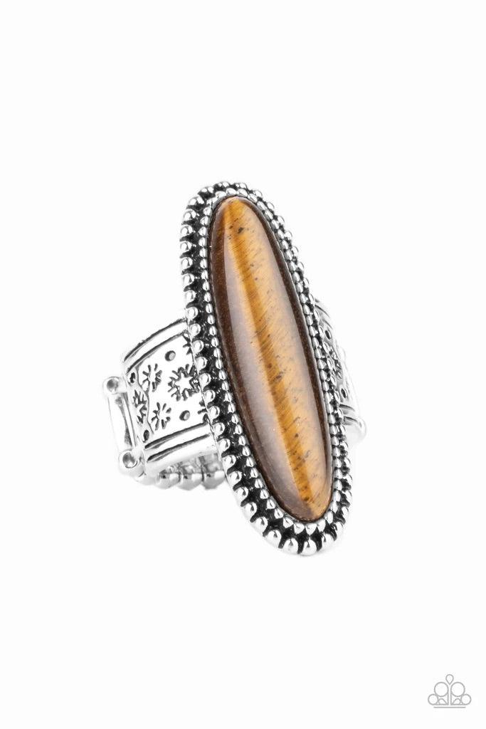 Paparazzi Accessories Ultra Luminary - Brown An oblong tiger's eye stone adorns the center of a studded silver frame that sits atop a thick silver band stamped in antiqued stars. Features a stretchy band for a flexible fit. Sold as one individual ring. Je