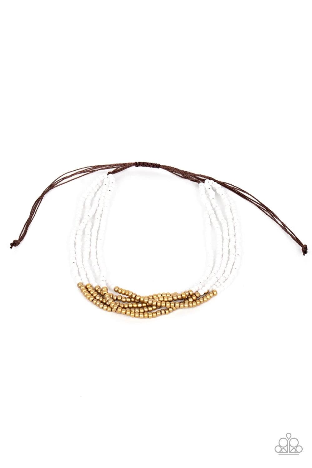 Paparazzi Accessories BEAD Bold - White Four strands of white seed beads accented with a bold section of brass seed beads wraps around the wrist for a simple yet trendy look. Features an adjustable sliding knot closure. Sold as one individual bracelet. Je