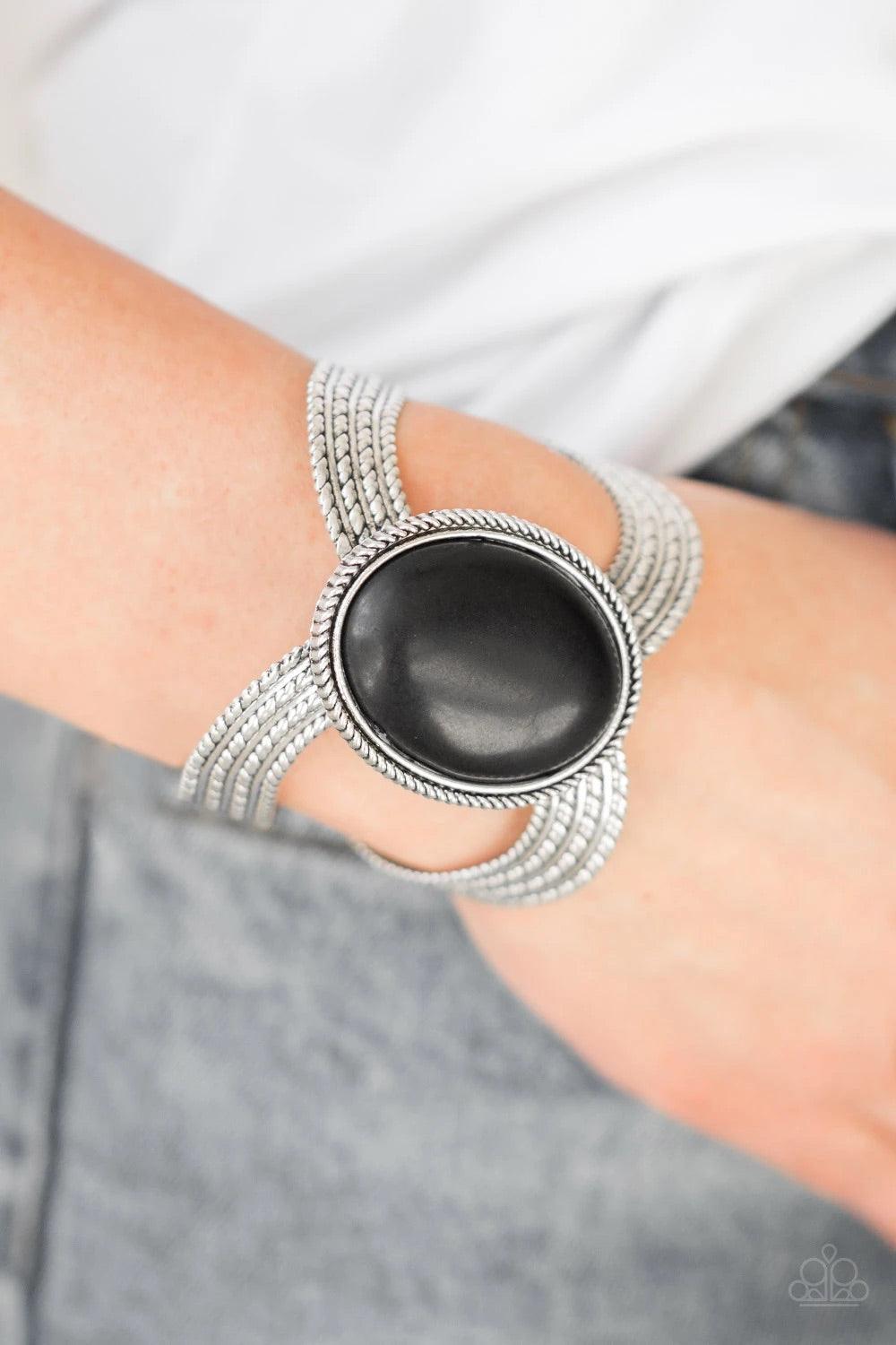 Paparazzi Accessories Coyote Couture - Black A dramatic black stone pendant is pressed into the center of textured silver bars, creating a bold seasonal cuff. Sold as one individual bracelet. Jewelry