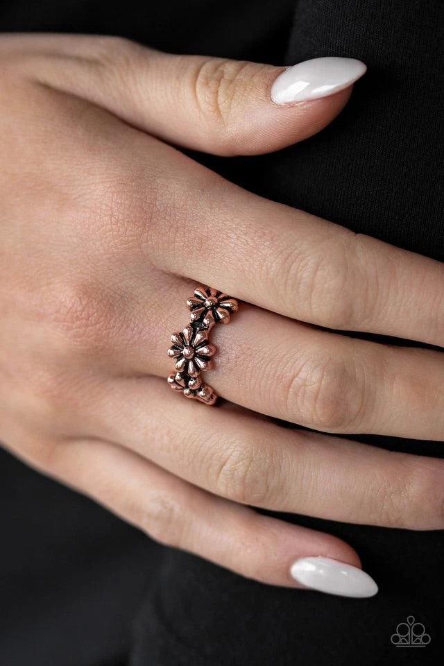 Paparazzi Accessories Daisy Dapper - Copper A row of dainty copper daisies connect across the finger, coalescing into a whimsical band. Features a dainty stretchy band for a flexible fit. Sold as one individual ring. Jewelry