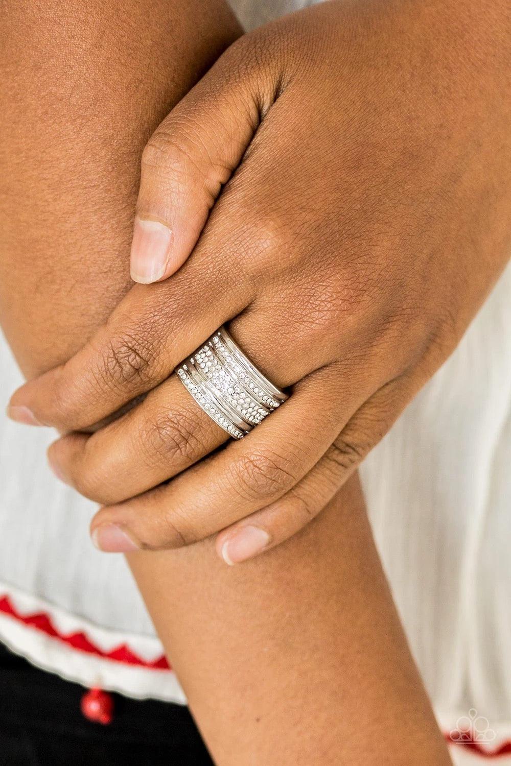 Paparazzi Accessories Top Dollar Drama - White Shimmery silver and white rhinestone encrusted bands stack across the finger for a glamorous look. Features a stretchy band for a flexible fit. Sold as one individual ring. Jewelry