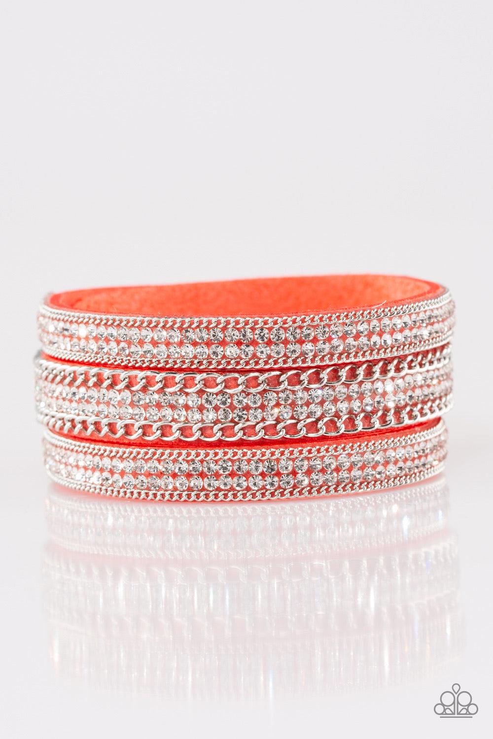 Paparazzi Accessories Dangerously Drama Queen - Orange Rows of shimmery silver chains and glassy white rhinestones are encrusted along a Blooming Dahlia suede band. The glittery band has been spliced into three strands, creating row after row of blinding