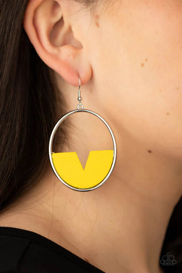 Paparazzi Accessories Island Breeze - Yellow Featuring a triangular cut, a crescent shaped yellow wooden frame is fitted in place along the bottom of a shiny silver hoop, creating a retro lure. Earring attaches to a standard fishhook fitting. Sold as one