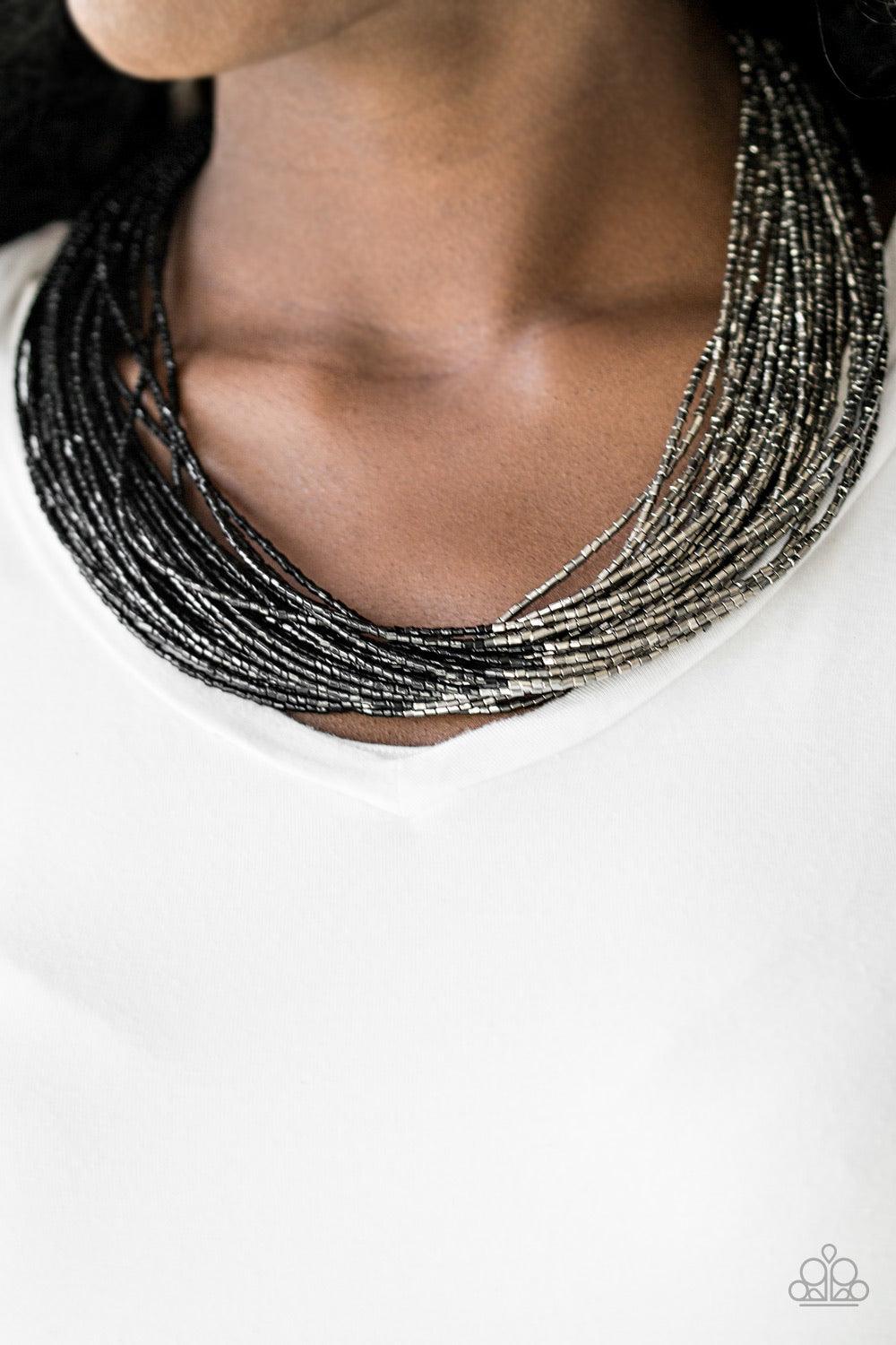 Paparazzi Accessories Flashy Fashion - Black Brushed in a flashy finish, countless strands of black seed beads converge with strands of gunmetal seed beads, creating colorful layers below the collar. Features an adjustable clasp closure. Sold as one indiv