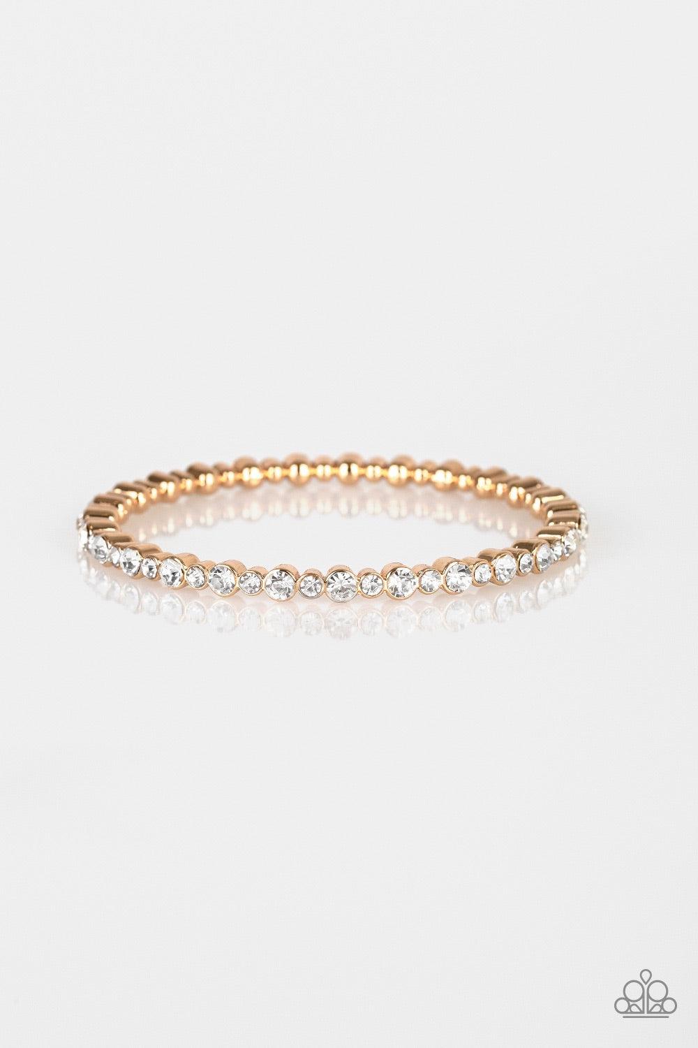 Paparazzi Accessories Seven Figure Fabulous - Gold A glistening gold bangle is encrusted in countless white rhinestones for a timeless look. Jewelry