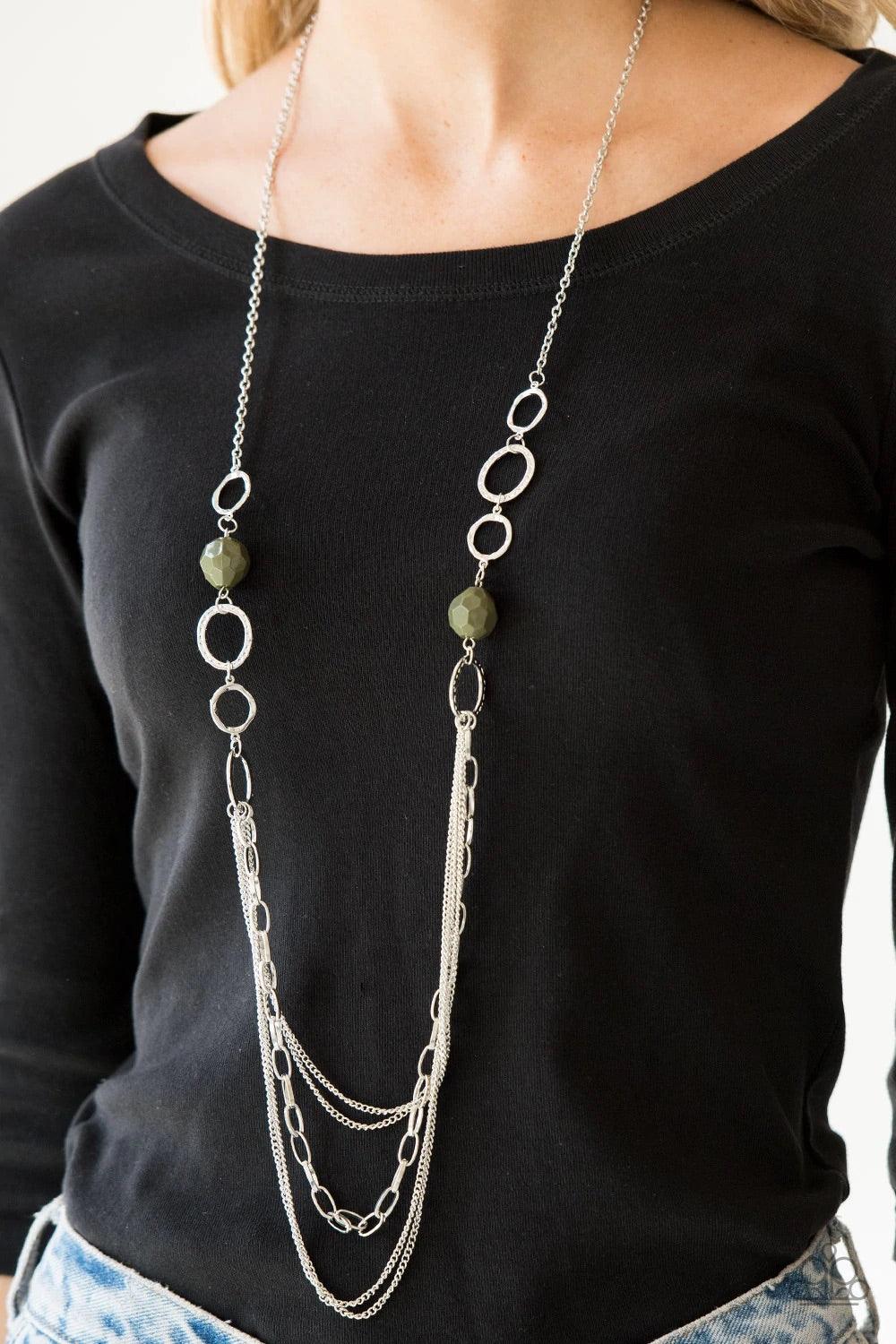 Paparazzi Accessories Margarita Masquerades - Green Faceted green beads and hammered silver hoops gives way to layers of mismatched silver chains for a whimsical look. Features an adjustable clasp closure. Sold as one individual necklace. Includes one pai