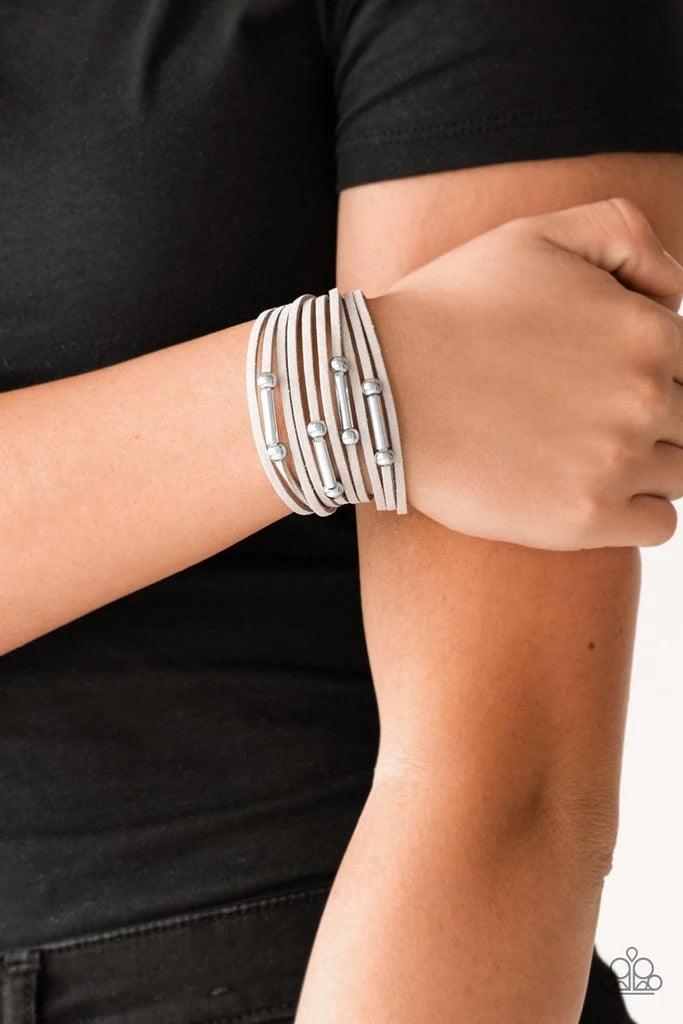 Paparazzi Accessories Back To BACKPACKER - Silver Strung between two silver fittings, glistening silver and gunmetal accents slide along strands of gray suede for a seasonal look. Features an adjustable clasp closure. Sold as one individual bracelet. Jewe