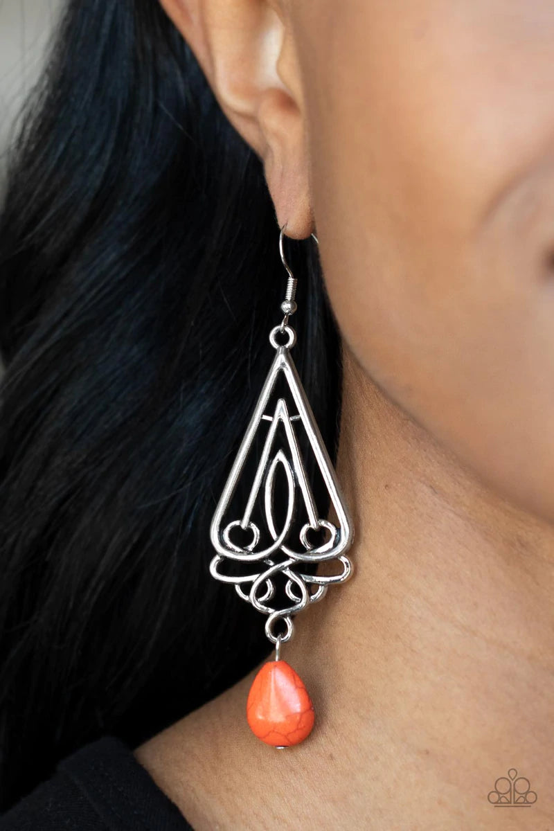 Paparazzi Accessories Transcendent Trendsetter - Orange A refreshing orange teardrop stone swings from the bottom of an ornate triangular frame, creating a seasonal statement. Earring attaches to a standard fishhook fitting. Sold as one pair of earrings.