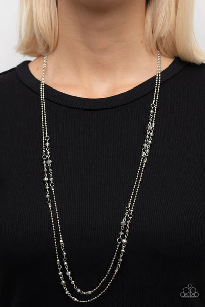 Paparazzi Accessories Petitely Prismatic - Silver Sections of iridescent and smoky crystal-like beads embellish strands of dainty gunmetal beaded chains, resulting in prismatic layers across the chest. Features an adjustable clasp closure. Sold as one ind