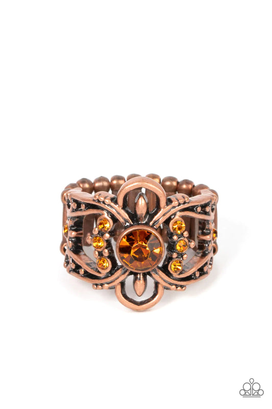 Paparazzi Accessories We Wear Crowns Here - Copper A solitaire topaz rhinestone is flanked by stacked rows of dainty topaz rhinestones inside swooping copper bars dotted in antiqued copper studs, resulting in a refined sparkle atop the finger. Features a