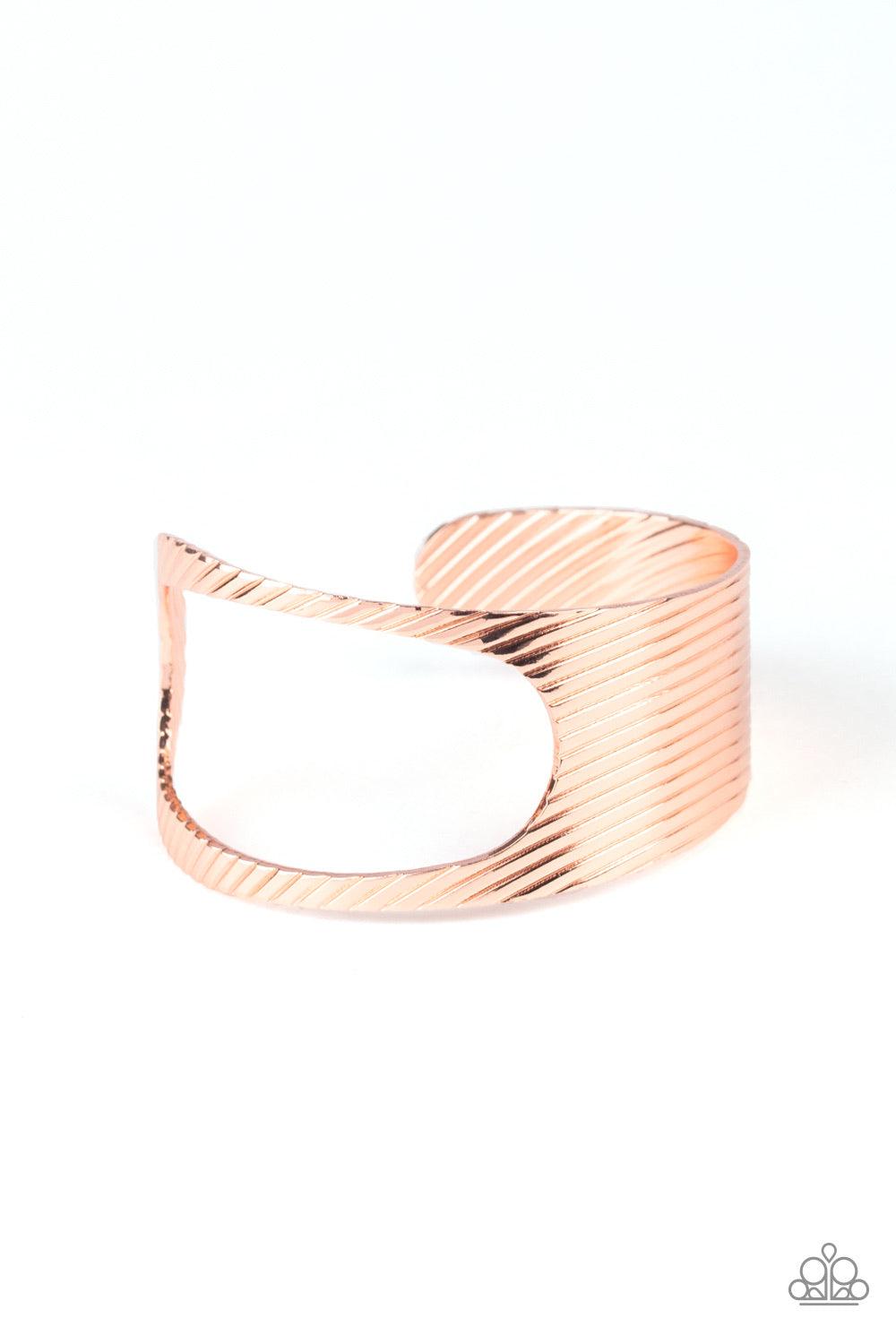 Paparazzi Accessories What GLEAMS Are Made of - Copper Stamped in a slanted linear pattern, a shiny copper cuff featuring an airy asymmetrical cutout wraps around the cuff for a bold industrial look. Bracelets