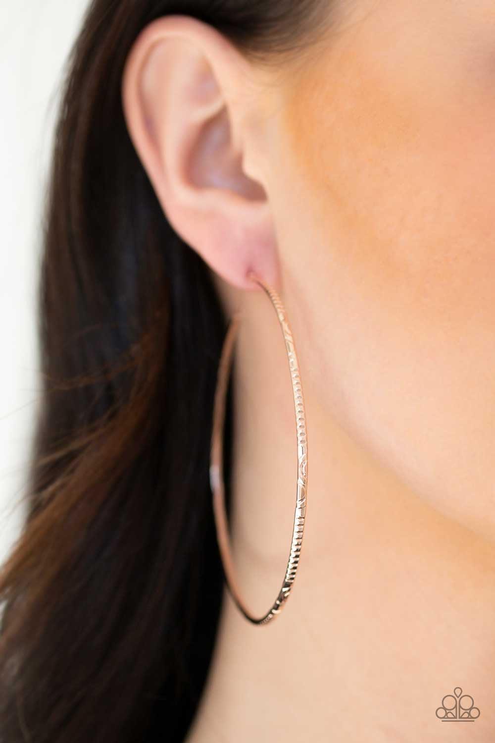 Paparazzi Accessories Sleek Fleek - Rose Gold Etched in mismatched textures, a dainty rose gold bar curls into a patterned hoop for a seasonal look. Earring attaches to a standard post fitting. Hoop measures 2 3/4" in diameter. Jewelry