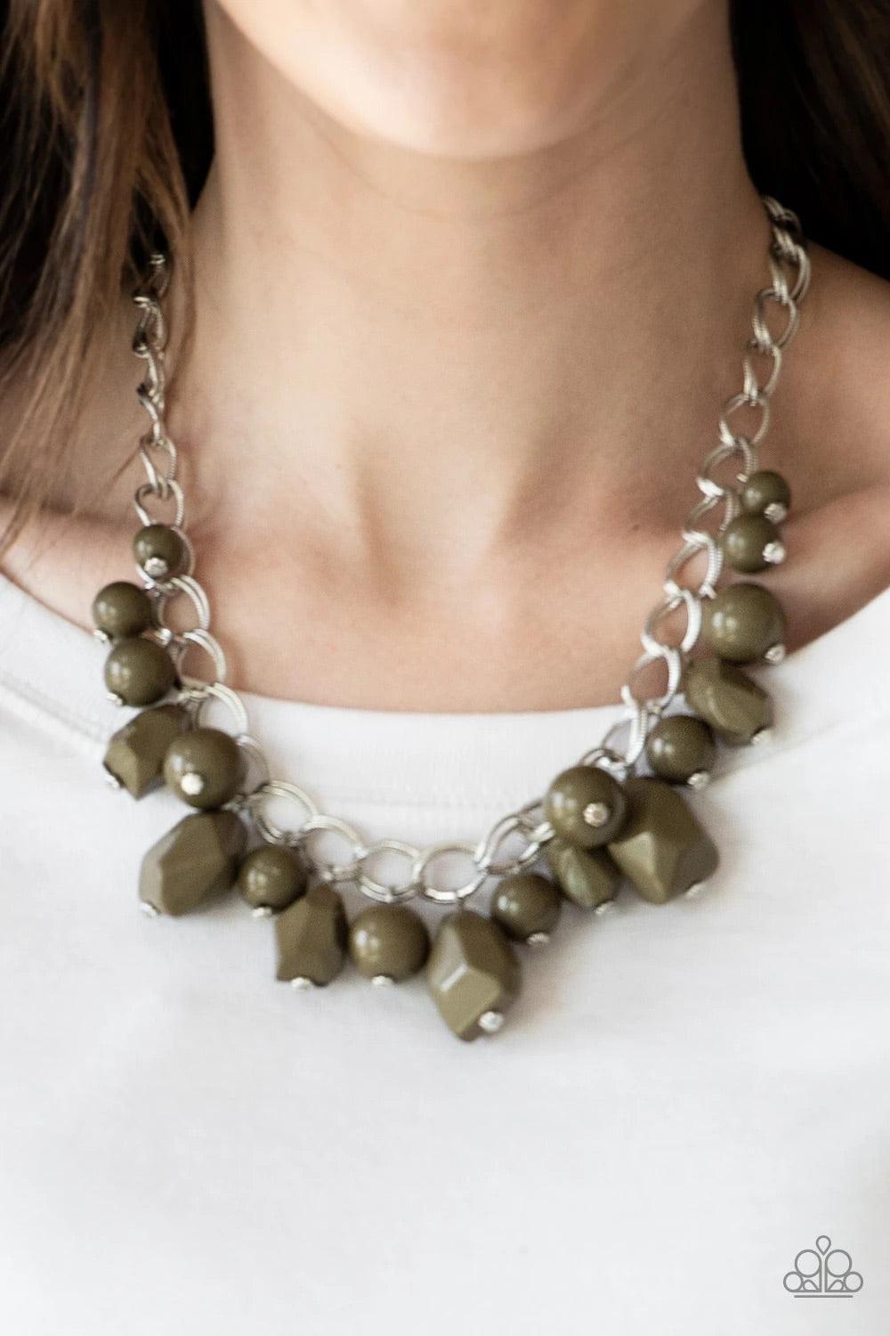 Paparazzi Accessories Gorgeously Globetrotter - Green Varying in shape and shimmer, smooth and faceted Martini Olive beads trickle from doubled silver chain links, creating a colorful fringe below the collar. Features an adjustable clasp closure. Sold as