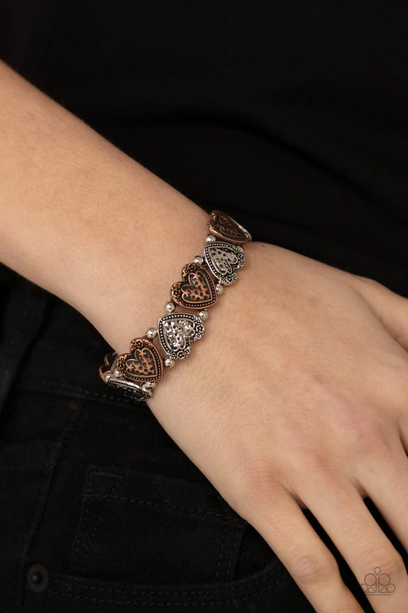 Paparazzi Accessories Rustic Heartthrob - Multi Adorned in dainty floral accents, hammered copper and silver heart frames and classic silver beads are threaded along stretchy bands around the wrist for a romantically rustic look. Sold as one individual br