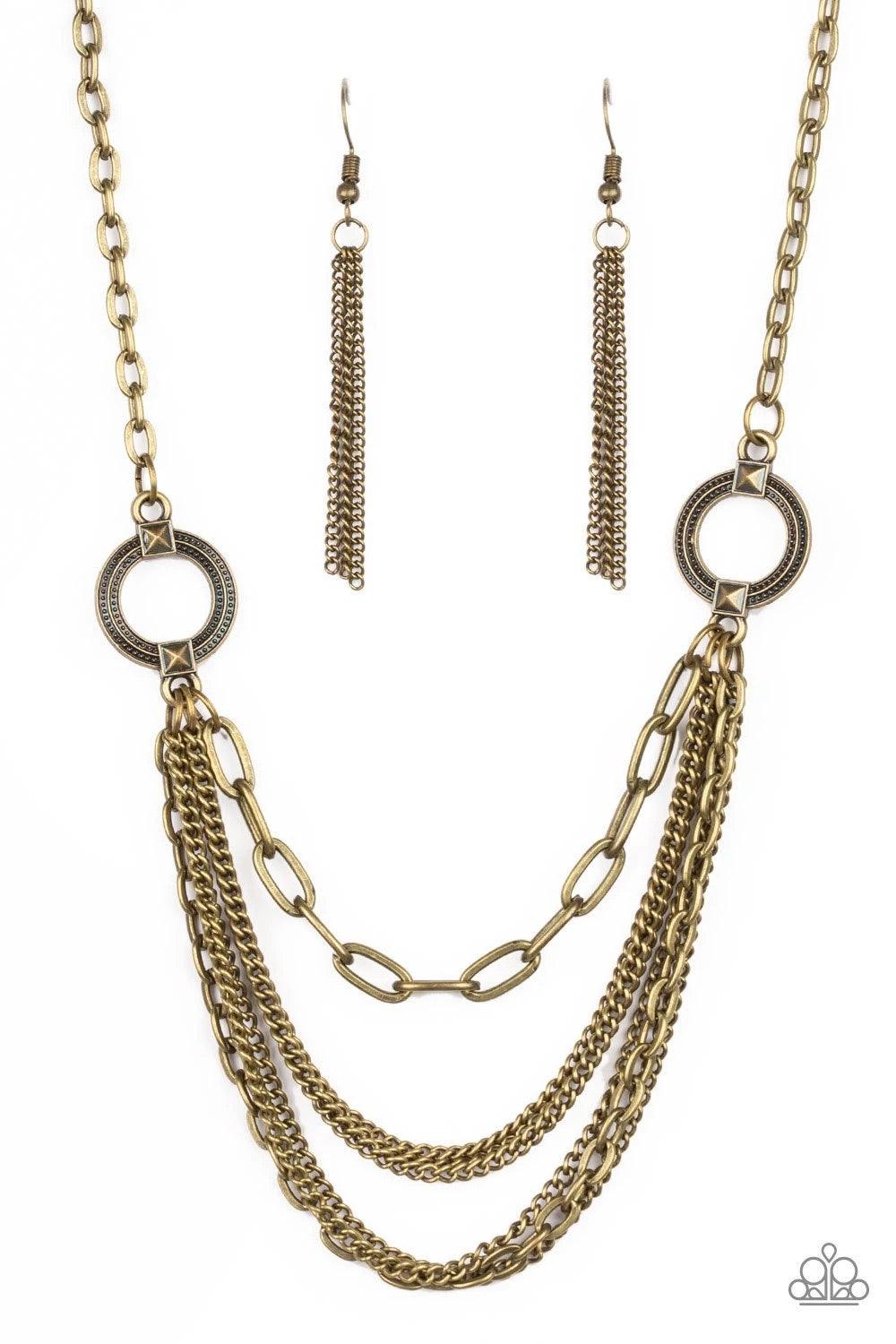 Paparazzi Accessories CHAINS of Command - Brass Ornate brass hoops give way to mismatched brass chains below the collar for an edgy industrial look. Features an adjustable clasp closure. Sold as one individual necklace. Includes one pair of matching earri