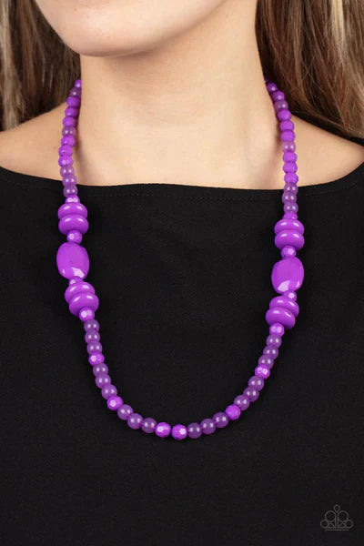 Paparazzi Accessories Tropical Tourist - Purple Varying in size, shape, and opacity, a vivacious purple collection of cloudy and solid acrylic beads drapes across the chest for a playful pop of color. Features an adjustable clasp closure. Sold as one indi